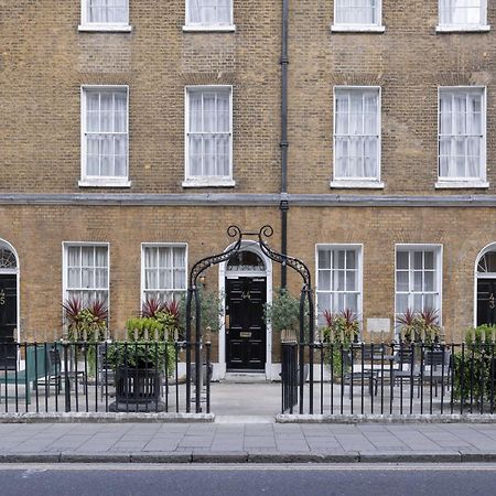 Montcalm Brewery Townhouse Hotell London Exteriör bild The photo shows a row of three-story brick buildings, featuring a classic design with large windows and decorative ironwork. The buildings are painted in a muted yellow-brown color, typical of older urban architecture. In front of the buildings, ther
