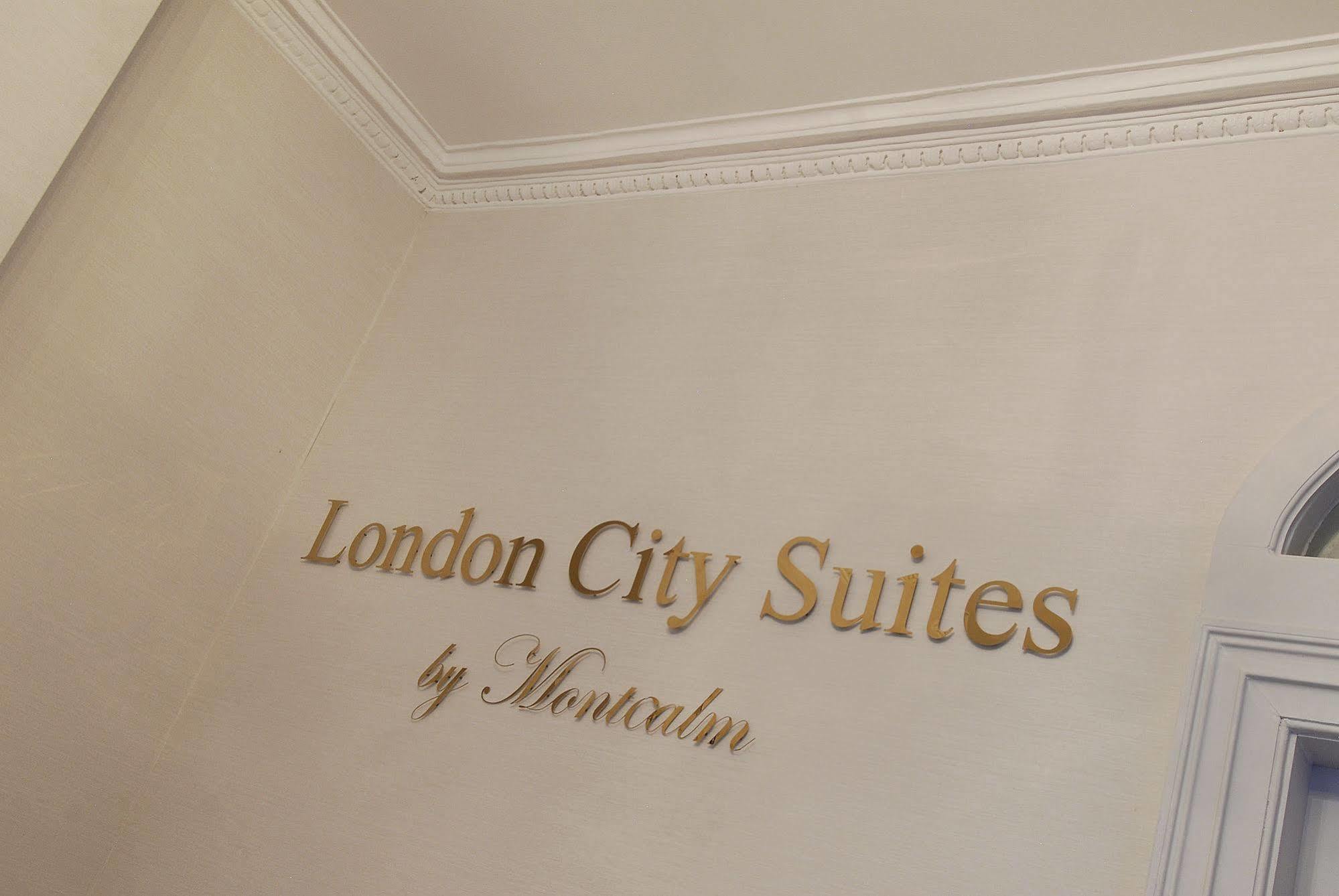 Montcalm Brewery Townhouse Hotell London Exteriör bild The photo shows a wall display featuring the text "London City Suites" in a bold, gold-colored font. Below that, the words "by Montcalm" are written in a smaller, elegant style. The background appears to be a neutral-colored wall, possibly in a hotel