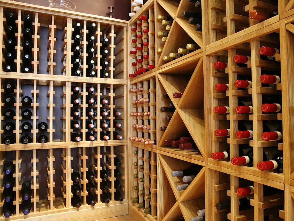 Montcalm Brewery Townhouse Hotell London Exteriör bild The photo shows a wine cellar with wooden racks designed for storing wine bottles. The structure is divided into sections, featuring various compartments that hold the bottles in an organized manner. The bottles have different colors, with many red a